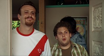 Movie still from “Knocked Up” (2007), directed by Judd Apatow – Two men standing next to each other in a room; Medium shot, Low angle