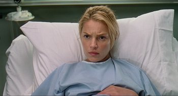 Movie still from “Knocked Up” (2007), directed by Judd Apatow – A woman laying in a hospital bed looking sad; Close Up shot, Low angle
