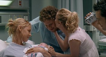 Movie still from “Knocked Up” (2007), directed by Judd Apatow – A man and two women looking at a baby in a hospital bed; Medium shot, Over the shoulder angle