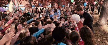 Movie still from “Knowing” (2009), directed by Alex Proyas – A crowd of people gathered in a park to celebrate; Wide shot, High angle