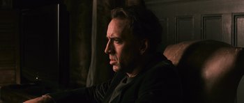 Movie still from “Knowing” (2009), directed by Alex Proyas – A person sitting in a chair; Close Up shot, Low angle