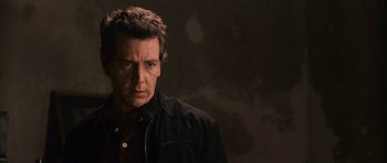 Movie still from “Knowing” (2009), directed by Alex Proyas – A person wearing a black jacket; Close Up shot, Low angle