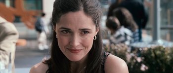 Movie still from “Knowing” (2009), directed by Alex Proyas – A woman's face with a smile on her face; Close Up shot, Over the shoulder angle