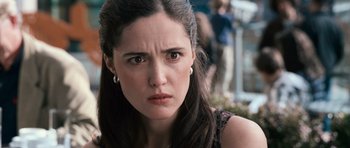 Movie still from “Knowing” (2009), directed by Alex Proyas – A person with long dark hair; Close Up shot, Over the shoulder angle