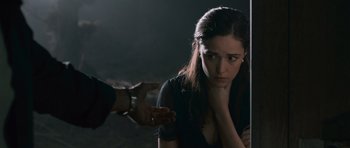 Movie still from “Knowing” (2009), directed by Alex Proyas – A woman in a black shirt and a man in a black shirt; Close Up shot, Over the shoulder angle