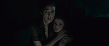 Movie still from “Knowing” (2009), directed by Alex Proyas – A woman and a young girl in a dark room; Close Up shot, High angle