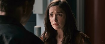 Movie still from “Knowing” (2009), directed by Alex Proyas – A person looking at a person; Close Up shot, Over the shoulder angle