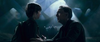 Movie still from “Knowing” (2009), directed by Alex Proyas – A man and a boy talking to each other; Medium shot, Over the shoulder angle