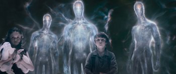 Movie still from “Knowing” (2009), directed by Alex Proyas – A young boy standing in front of an image of a man; Medium shot, Over the shoulder angle