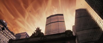 Movie still from “Knowing” (2009), directed by Alex Proyas – A large building with a sky background and a statue on top of it; Extreme Wide shot, Low angle
