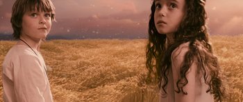 Movie still from “Knowing” (2009), directed by Alex Proyas – A woman standing in the middle of a wheat field; Close Up shot, High angle