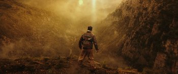 Movie still from “Kong: Skull Island” (2017), directed by Jordan Vogt-Roberts – A man standing on top of a mountain looking into the distance; Extreme Wide shot, High angle