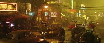 Movie still from “Kong: Skull Island” (2017), directed by Jordan Vogt-Roberts – A city street with a lot of traffic and people on the sidewalk; Extreme Wide shot, High angle