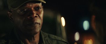 Movie still from “Kong: Skull Island” (2017), directed by Jordan Vogt-Roberts – A person wearing a hat; Close Up shot, Over the shoulder angle