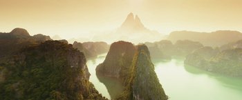 Movie still from “Kong: Skull Island” (2017), directed by Jordan Vogt-Roberts – A large body of water surrounded by mountains; Extreme Wide shot, High angle
