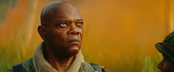 Movie still from “Kong: Skull Island” (2017), directed by Jordan Vogt-Roberts – An older black man with a bag in his hand; Close Up shot, Low angle