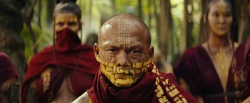 Movie still from “Kong: Skull Island” (2017), directed by Jordan Vogt-Roberts – A man with yellow paint on his face; Close Up shot, Low angle