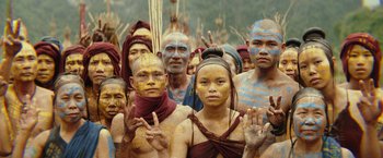 Movie still from “Kong: Skull Island” (2017), directed by Jordan Vogt-Roberts – A large group of people with faces painted; Medium shot, High angle