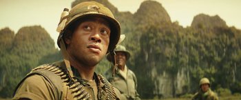 Movie still from “Kong: Skull Island” (2017), directed by Jordan Vogt-Roberts – A man in a military uniform and a man in a hat; Close Up shot, Low angle