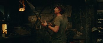 Movie still from “Kong: Skull Island” (2017), directed by Jordan Vogt-Roberts – A man holding an axe in his hands; Medium shot, Over the shoulder angle