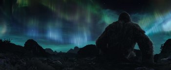 Movie still from “Kong: Skull Island” (2017), directed by Jordan Vogt-Roberts – A night sky filled with green and blue lights; Extreme Wide shot, Low angle