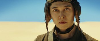 Movie still from “Kong: Skull Island” (2017), directed by Jordan Vogt-Roberts – A young man wearing an aviator's hat and goggles; Close Up shot, Low angle