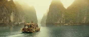 Movie still from “Kong: Skull Island” (2017), directed by Jordan Vogt-Roberts – A boat with people on it in the middle of a lake; Extreme Wide shot, High angle