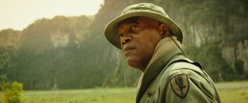 Movie still from “Kong: Skull Island” (2017), directed by Jordan Vogt-Roberts – A man in a hat and jacket looking into the distance; Close Up shot, Low angle
