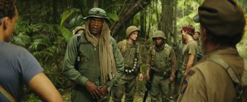 Movie still from “Kong: Skull Island” (2017), directed by Jordan Vogt-Roberts – A group of men walking through the woods; Medium shot, Low angle