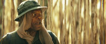 Movie still from “Kong: Skull Island” (2017), directed by Jordan Vogt-Roberts – A person wearing a hat; Close Up shot, Over the shoulder angle
