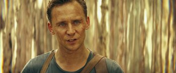 Movie still from “Kong: Skull Island” (2017), directed by Jordan Vogt-Roberts – A person wearing a shirt; Close Up shot, Over the shoulder angle