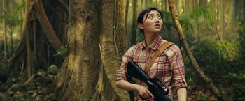 Movie still from “Kong: Skull Island” (2017), directed by Jordan Vogt-Roberts – A woman holding a rifle in a forest; Medium shot, Low angle