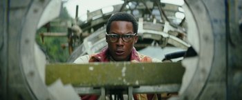 Movie still from “Kong: Skull Island” (2017), directed by Jordan Vogt-Roberts – A man wearing glasses looking at the camera; Close Up shot, Low angle