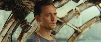 Movie still from “Kong: Skull Island” (2017), directed by Jordan Vogt-Roberts – A person wearing a shirt; Close Up shot, Over the shoulder angle