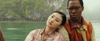 Movie still from “Kong: Skull Island” (2017), directed by Jordan Vogt-Roberts – A woman sitting next to a man on a boat; Close Up shot, Low angle