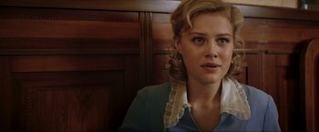 Movie still from “Lamborghini: The Man Behind the Legend” (2022), directed by Bobby Moresco – A woman with blonde hair wearing a blue dress; Close Up shot, Low angle