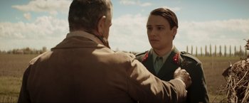 Movie still from “Lamborghini: The Man Behind the Legend” (2022), directed by Bobby Moresco – An older man and a young man in military uniforms; Close Up shot, Over the shoulder angle