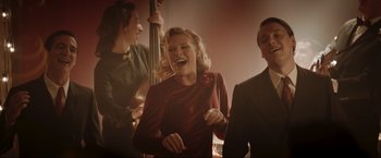 Movie still from “Lamborghini: The Man Behind the Legend” (2022), directed by Bobby Moresco – A group of people that are standing up; Medium shot, Low angle