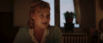 Movie still from “Lamborghini: The Man Behind the Legend” (2022), directed by Bobby Moresco – A woman sitting in front of a window; Close Up shot, Over the shoulder angle