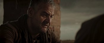 Movie still from “Lamborghini: The Man Behind the Legend” (2022), directed by Bobby Moresco – An older man sitting in front of a brick wall; Close Up shot, Over the shoulder angle