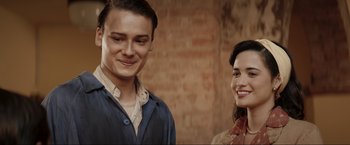 Movie still from “Lamborghini: The Man Behind the Legend” (2022), directed by Bobby Moresco – A man and a woman standing next to each other; Close Up shot, Over the shoulder angle