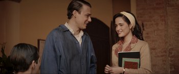 Movie still from “Lamborghini: The Man Behind the Legend” (2022), directed by Bobby Moresco – A man and a woman are talking to each other; Medium shot, Over the shoulder angle