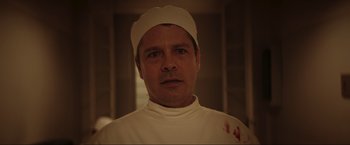 Movie still from “Lamborghini: The Man Behind the Legend” (2022), directed by Bobby Moresco – A person wearing a hat with blood on it; Close Up shot, Low angle