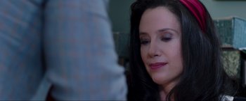 Movie still from “Lamborghini: The Man Behind the Legend” (2022), directed by Bobby Moresco – A person with long black hair; Close Up shot, Over the shoulder angle