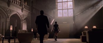 Movie still from “Lara Croft: Tomb Raider” (2001), directed by Simon West – A man and a woman walking down a staircase; Wide shot, Low angle