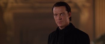 Movie still from “Lara Croft: Tomb Raider” (2001), directed by Simon West – A person wearing a black shirt; Close Up shot, Low angle