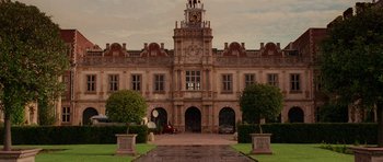 Movie still from “Lara Croft: Tomb Raider” (2001), directed by Simon West – A large building with a clock on the top of it; Extreme Wide shot, Low angle