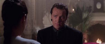 Movie still from “Lara Croft: Tomb Raider” (2001), directed by Simon West – A person wearing a suit and tie; Close Up shot, Over the shoulder angle