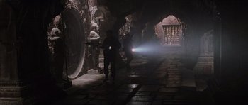Movie still from “Lara Croft: Tomb Raider” (2001), directed by Simon West – A group of people walking down a dark street; Wide shot, High angle