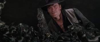 Movie still from “Lara Croft: Tomb Raider” (2001), directed by Simon West – A person wearing a cowboy hat; Medium shot, High angle